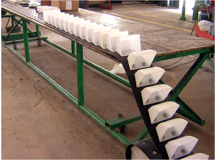 Cangilones plásticos blancos montados en banda de elevador para transporte de granos y semillas